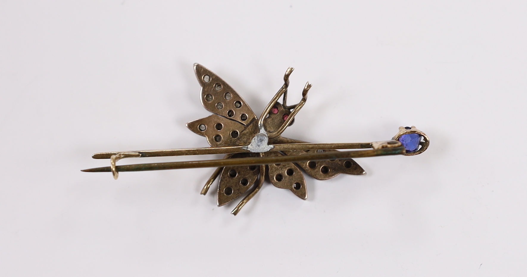A Victorian yellow metal, rose cut diamond, ruby and blue stone doublet set bug bar brooch, 54mm, gross weight 7.3 grams.